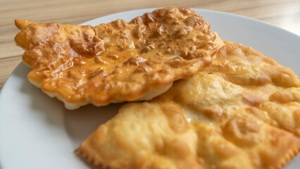 Homemade pasties with meat filling on white plate. traditional Caucasian and Russian cuisine. Take away food concepts