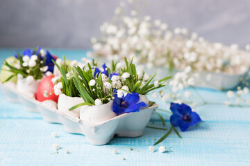 Easter. Painted eggs. Grass and flowers in a shell. Easter Still Life