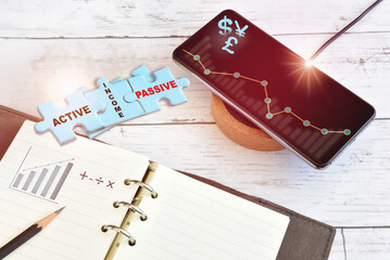 Income earning finance technology growth graph on smart phone on wireless charger with active and...