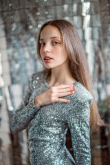 Beautiful girl in a sparkly dress and birthday boy cap in the studio