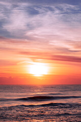 Fototapeta na wymiar Orange lit sunrise skies over ocean. Gold Coast, Australia