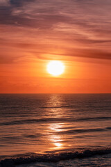Orange lit sunrise skies over ocean. Gold Coast, Australia