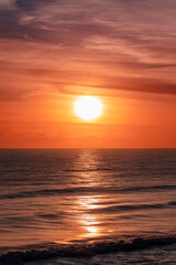 Orange lit sunrise skies over ocean. Gold Coast, Australia