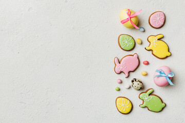 holiday preparation Multi colors Easter eggs with cookies on colored background . Pastel color Easter eggs. holiday concept with copy space