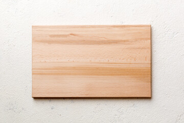 Top view of wooden cutting board on cement background. Empty space for your design