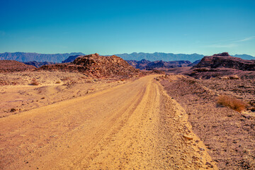 Fototapeta na wymiar Mountain desert landscape. Dirt road in Timna Park, Eilat, Israel