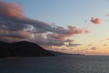 Fototapeta premium Sunset over the Mediterranean sea with clear sky. Sun over the water with cloudy atmospheric moods