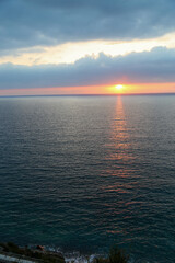 Sunset over the Mediterranean sea with clear sky. Sun over the water