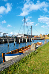 Boat and ships in the Roskilde harbor, Denmark. Sunny day on a summer vacation.