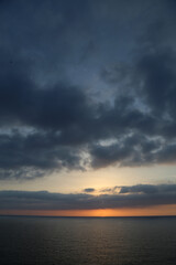 Fototapeta na wymiar Sunset over the Mediterranean sea with clear sky. Sun over the water with cloudy atmospheric moods