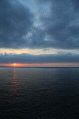 Sunset over the Mediterranean sea with clear sky. Sun over the water with cloudy atmospheric moods