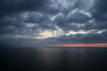 Sunset over the Mediterranean sea with clear sky. Sun over the water with cloudy atmospheric moods