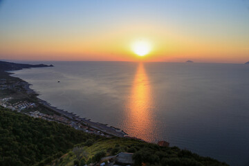 Fototapeta na wymiar Sunset over the Mediterranean sea with clear sky. Sun over the water