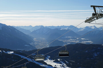 ski lift and the alps in tirol in the background - ski slopes rosshütte