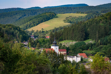 Fototapeta na wymiar view of green countryside during summer village and church in valley
