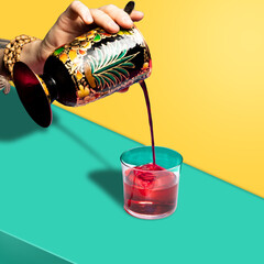 cocktail minimalism. cocktail on a colored background. cocktail in hand