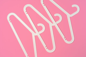 Flat lay composition with empty hangers on pink background