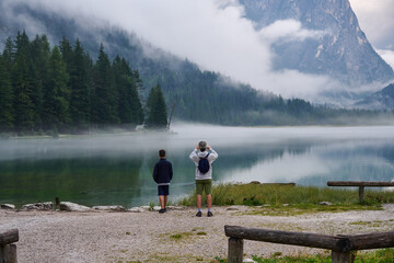 Men in the fog on Lake Toblach - Dolomites, Italy