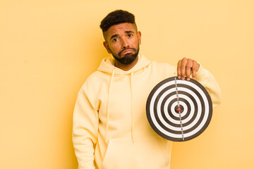 afro cool man feeling sad and whiney with an unhappy look and crying. dart target concept