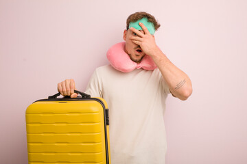 young cool man looking shocked, scared or terrified, covering face with hand. flight passenger concept