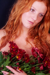 Naklejka premium seductive sensual young sexy redhead valentine with a bouquet of flowers looking like botticelli's venus