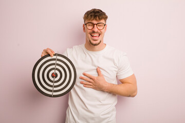 young cool man laughing out loud at some hilarious joke. dart target concept