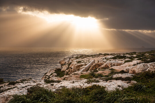 Malta - a beautiful sunset over Mditerranean Sea, view over Filfla island
