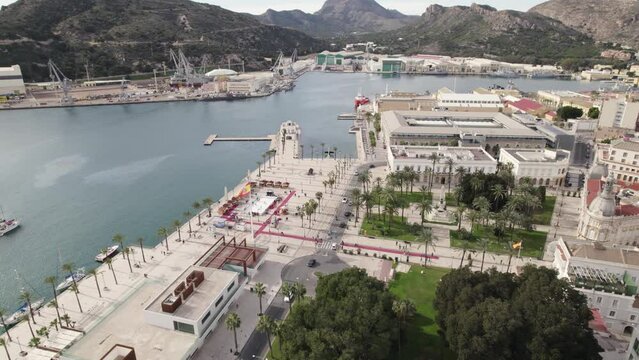 Cartagena touristic port and cityscape with El Zulo sculpture in background, Spain. Aerial circling