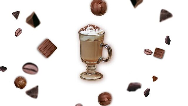 Flying and wiggle of different diameters and sides many chocolate chips and coffee beans around a cup of  latte  on a white color background. Beverage for morning energy breakfast concept. cafe or cof