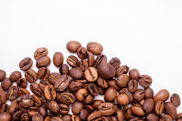 fragrant beans from the coffee tree in medium roast lie on a white background with a place for text