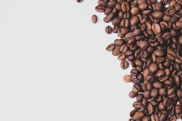 medium rare brown arabica coffee beans lie on a white background for text