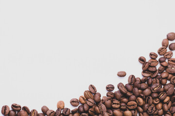 medium rare brown arabica coffee beans lie on a white background for text