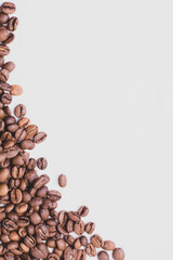 medium rare brown arabica coffee beans lie on a white background for text