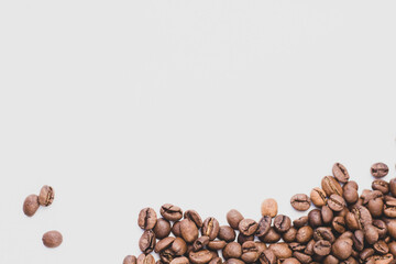 medium rare brown arabica coffee beans lie on a white background for text