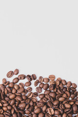 medium rare brown arabica coffee beans lie on a white background for text
