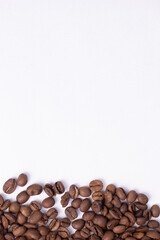 medium rare brown arabica coffee beans lie on a white background for text