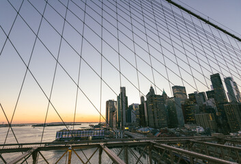 Beautiful sunset background of NYC from the Brooklyn Bridge.