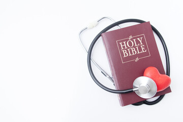 Holi bible and red heart with medical stethoscope. Soul healing, mental health and healing concept....