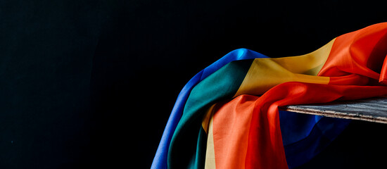 rainbow flag on a rustic table, web banner