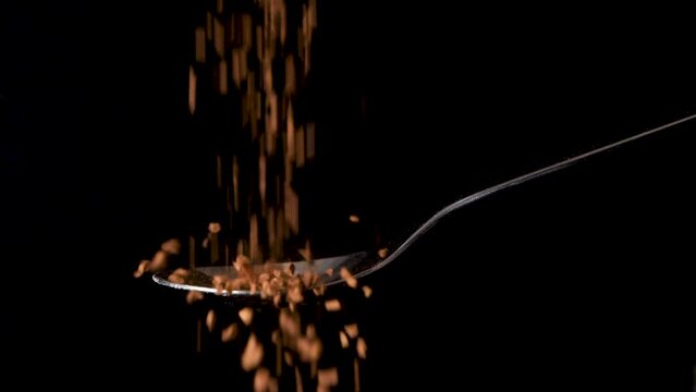 Overfill spoon with Instant coffee powder slow motion, concept of addiction.