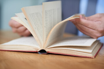 Make your success story a page turner. Cropped shot of an unidentifiable man reading a book.