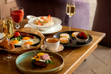 breakfast table with a variety of dishes and drinks