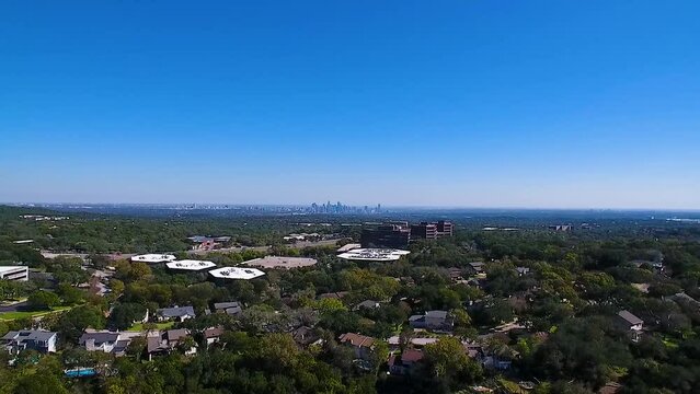 Aerial drone pulls back from the Austin, Texas skyline revealing loop 1 Mopac and the greenbelt