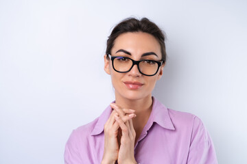 Young woman in a lilac shirt on a white background in glasses for vision cheerful positive in a good mood