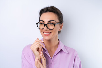 Young woman in a lilac shirt on a white background in glasses for vision cheerful positive in a good mood