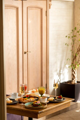 breakfast table with a variety of dishes and drinks