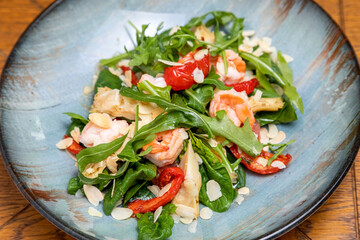 fresh salad served with a glass of wine. served table