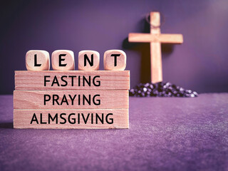 Lent Season,Holy Week and Good Friday concepts - words ' lent fasting praying almsgiving' on wooden...