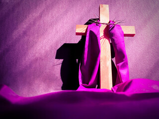 Lent Season,Holy Week and Good Friday concepts - image of wooden cross in purple vintage background. Stock photo.
