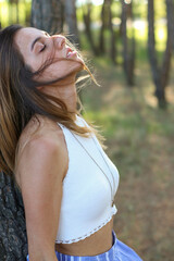 Young woman portrait in forest with closed eyes